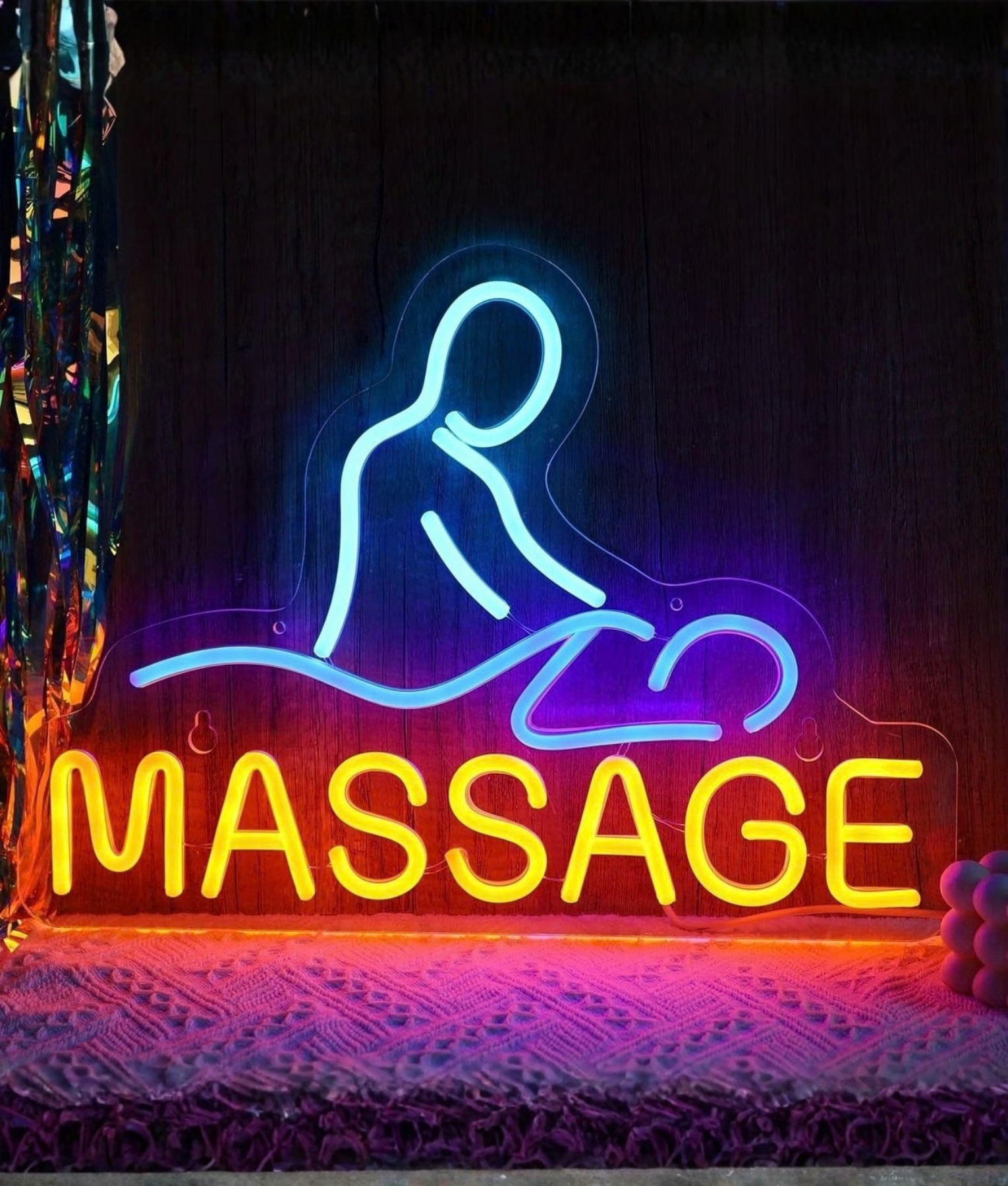 Massage neon lamp, een figuur op een massagetafel met de tekst Massage in blauw en geel