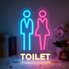 Toilet neon lamp, een toiletbordje met een man en een vrouw in blauw, roze en wit
